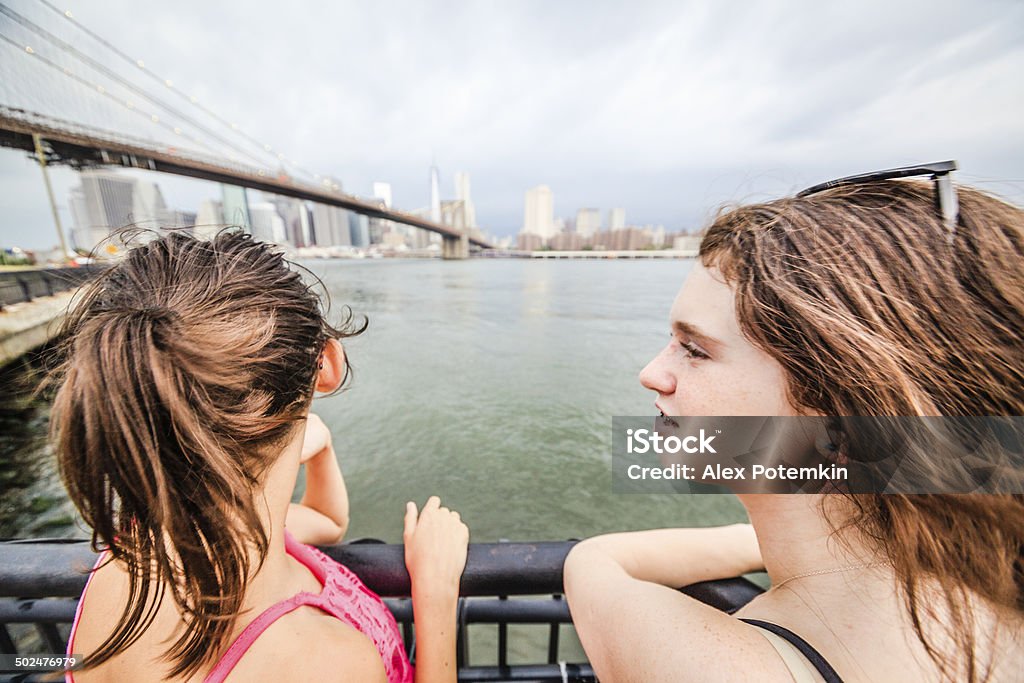 Two girls, sisters, looking to Manhattan under thunderstorm Two girls, sisters, looking to Manhattan under thunderstorm from Brooklyn Bridge Park, Brooklyn, New York  10-11 Years Stock Photo