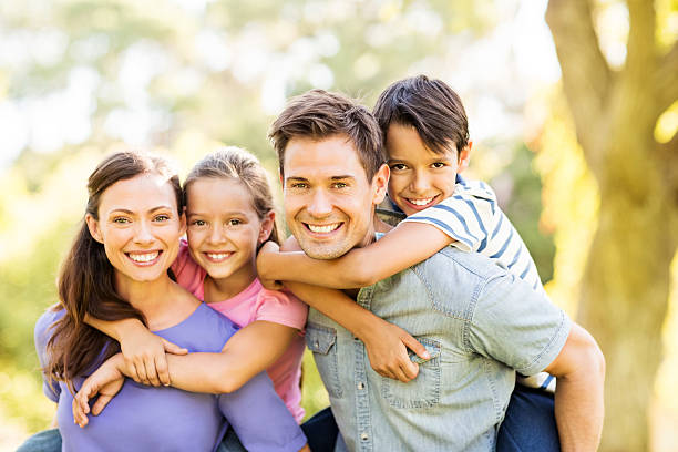 istock Cheerful Parents Piggybacking Children 502478371