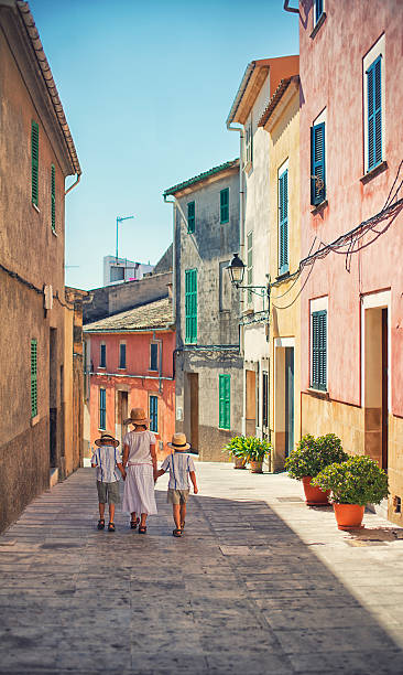 istock Kids walking in beautiful mediterranean town. 502478931