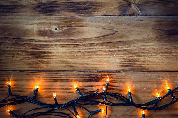 istock Christmas background - vintage planked wood with lights and text 502482940