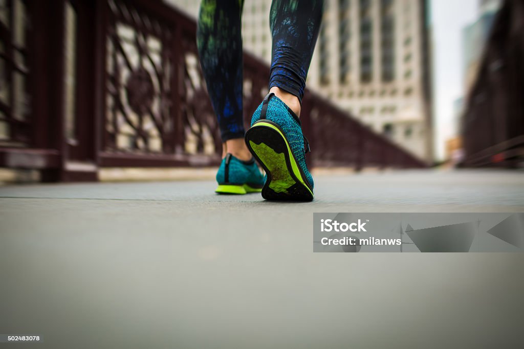 woman athlete feet and shoes while running woman athlete feet and shoes while running in the city 2015 Stock Photo