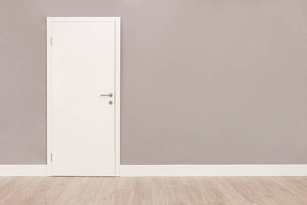 istock White door in an empty room 502484756