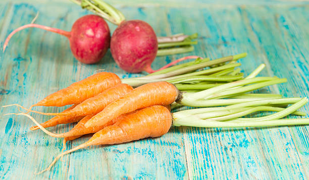 istock Fresh organic carrots and beetroot on  wooden 502485416