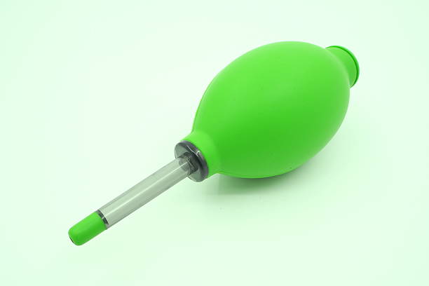 istock Green camera cleaning vacuum pump isolated on white background 502486344