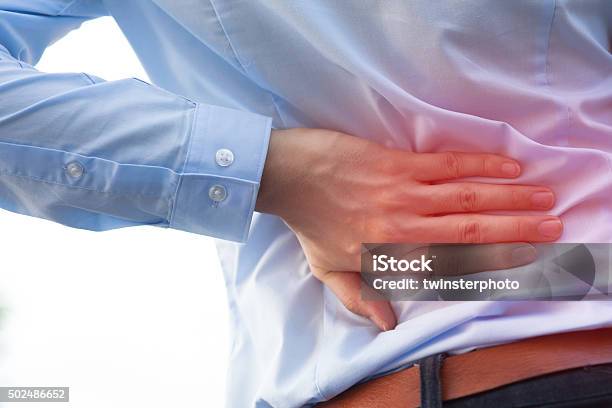 Man In Office Uniform Having Back Pain Back Injury Stock Photo - Download Image Now