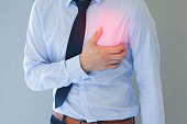Man having heart-attack / chest pain in isolated background