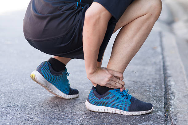 istock Runner touching painful twisted or broken ankle. Runner training accident 502487246