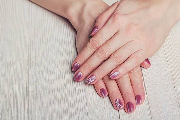 istock Pink nail art with white dots and lines 502487904