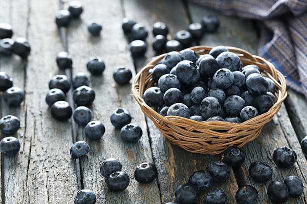 istock Blueberries in basket on a blue wooden background 502496110