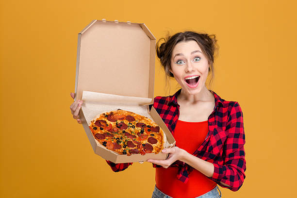 istock Portrait of charming amusing young woman holding pizza 502496812
