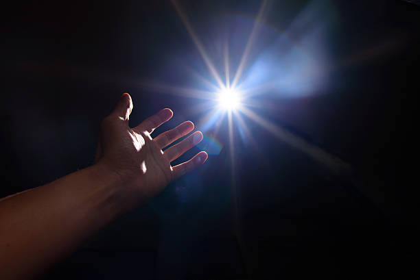 istock light and hand in the dark 502497788
