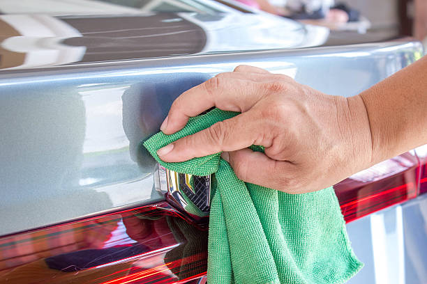 istock hand with microfiber wipe back of the car 502511336