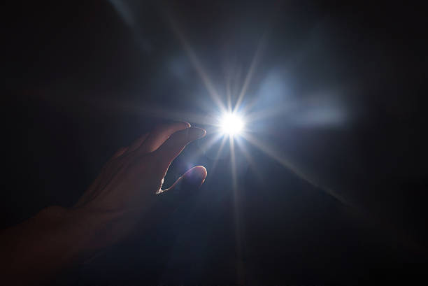 istock hand seeking light in the dark 502513294
