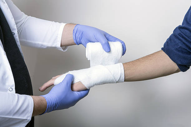 istock Pediatrician wrapping wrist of patient during exam 502517150