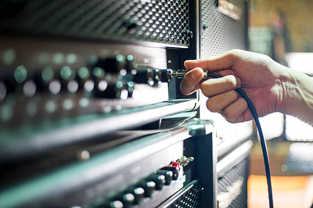 istock Closed up hand holding jack plug-in to the guitar amplifier 502517720