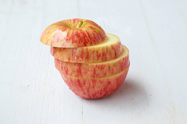 istock apple slices on white wooden background 502518320