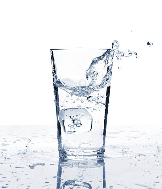 istock Glass of water with ice and splash 502519054