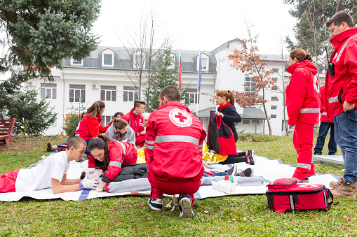 Sofia, Bulgaria - December 5, 2015: Volunteers from the Bulgarian Red Cross Youth Organization are participating in a training of saving people from a building during an earthquake. 