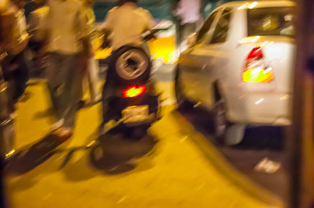 Night traffic on Delhi. At night jam mixed pedestrians, bikes and cars. Delhi, India.