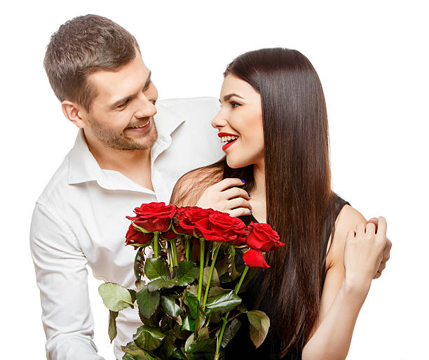istock Young beautiful couple with flowers isolated on white 502521704