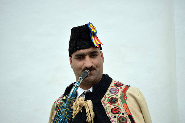 istock Gipsy singing traditional Romanian carols at saxophone. 502522704