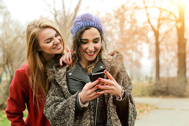 istock Girl texting message on Smart Phone With Friend 502522748