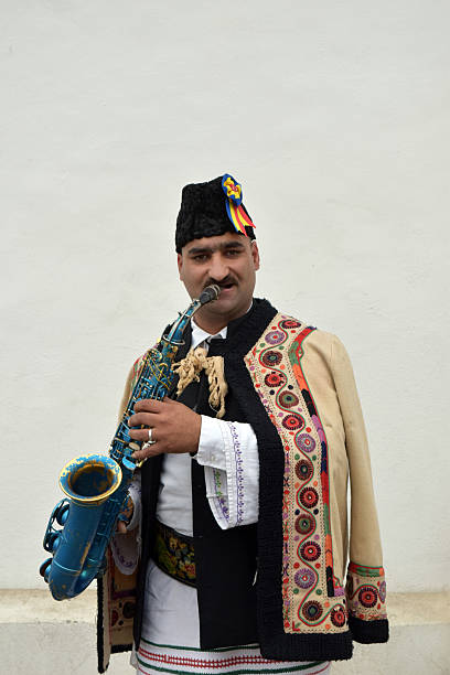 istock Gipsy singing traditional Romanian carols at saxophone. 502522800