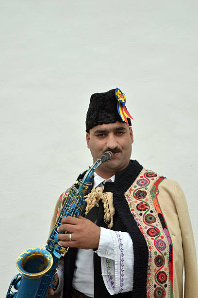 istock Gipsy singing traditional Romanian carols at saxophone. 502522820