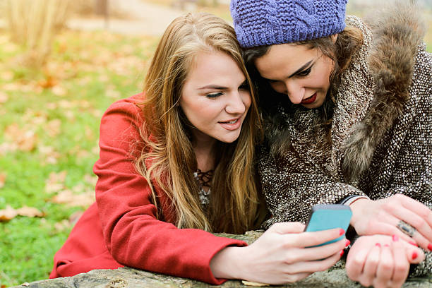 istock Two girls looking ath mobile phone in nature 502523014