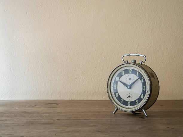 istock Alarm clock on wooden table 502523938
