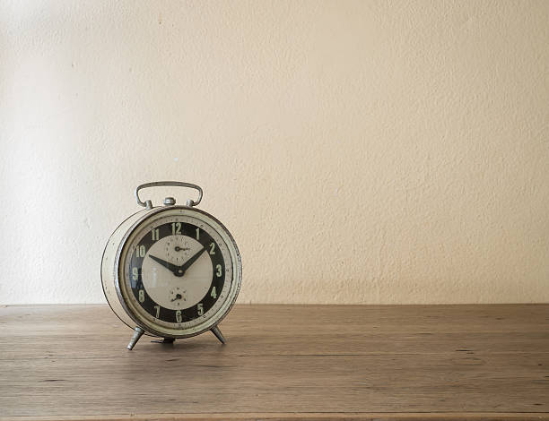 istock Alarm clock on wooden table 502524038
