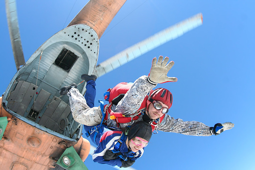 Tandem jump, the instructor and the passenger jump out of a helicopter.