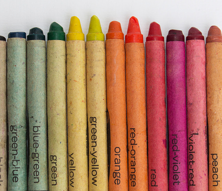 Close-up photo of colored crayons taken in a light box with a white background.  The best friend of children who love to draw.