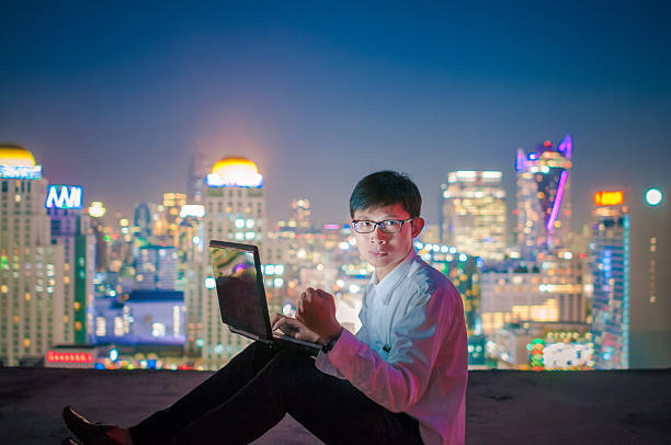 istock Businessman using a laptop on the rooftop of a skyscraper 502527058