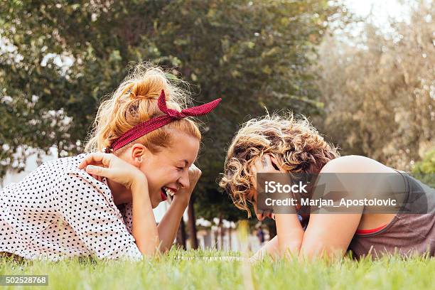 Girlfriends Laughing In The Park Stock Photo - Download Image Now - 2015, Adult, Beautiful People