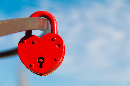 Red castle in the form of heart. Marriage love symbol padlock.