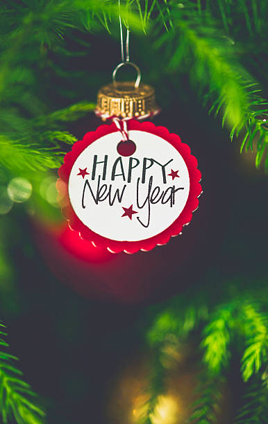 istock Christmas bauble with New Year message on Christmas tree branches 502530050