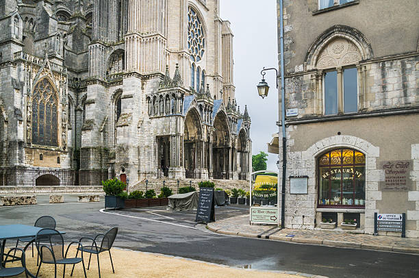Cathedral and Cafe  Chartres, France - May 26, 2014: A small restaurant with a collection of teapots in the window caters to the many visitors at the ancient Chartres Cathedral nearby. chartres cathedral stock pictures, royalty-free photos & images