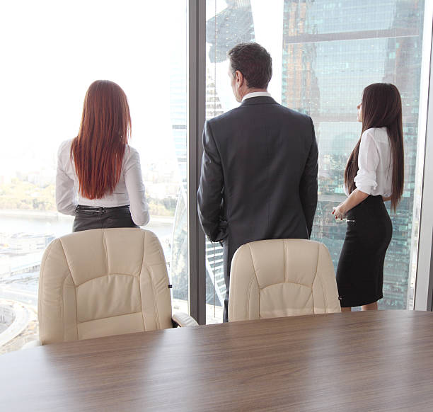 istock Business people looking at window 502543498