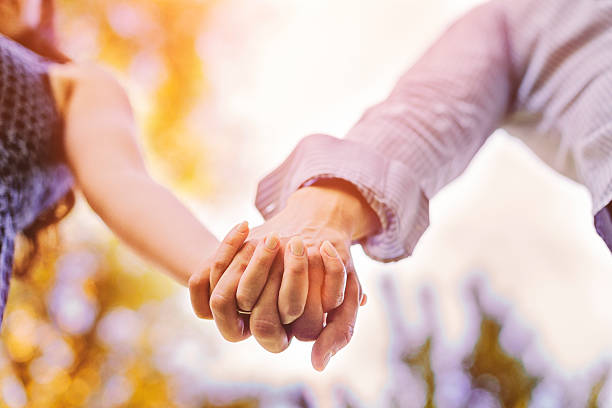 istock Close up on couple holding hands 502547628