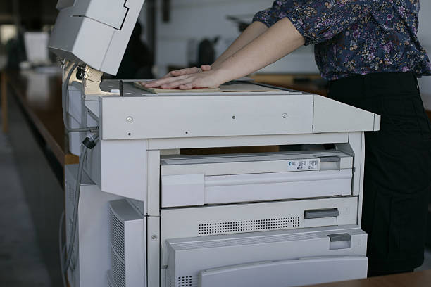 istock Hands on a book on a photocopier 502549258