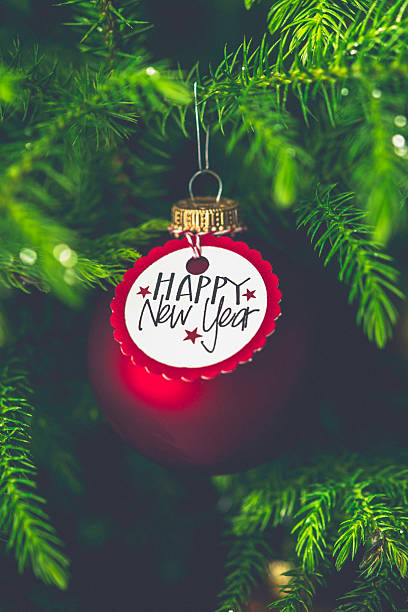 istock Christmas bauble with New Year message on Christmas tree branches 502549580