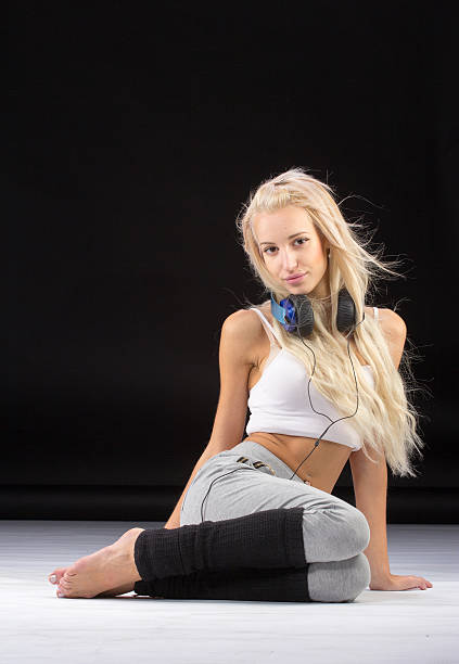 istock Young slim woman sitting on knees. 502549660