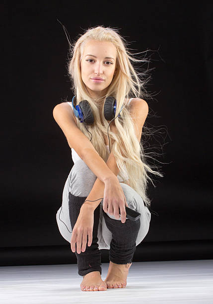 istock Young slim woman sitting on knees. 502549674