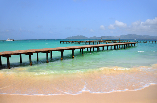 Blowing Point, Anguilla: beach and old wooden pier, Saint Martin in the background - photo by M.Torres
