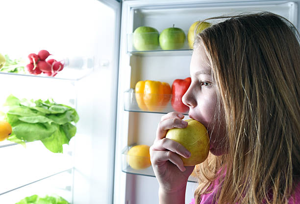 istock Girl  with fruits and vegetables 502552964