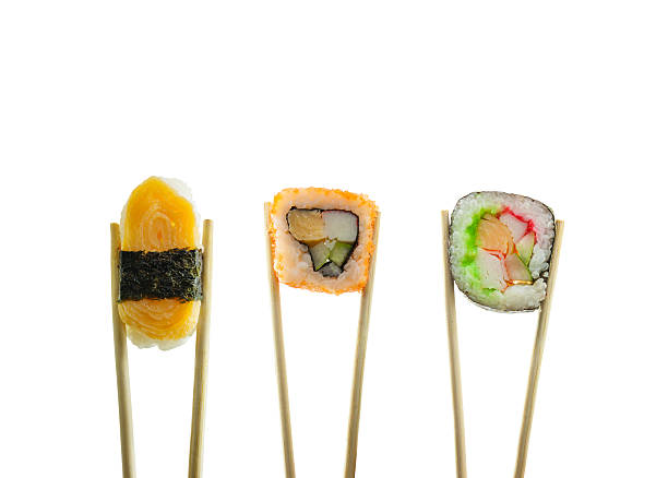 istock Sushi in chopsticks isolated on white background 502554428