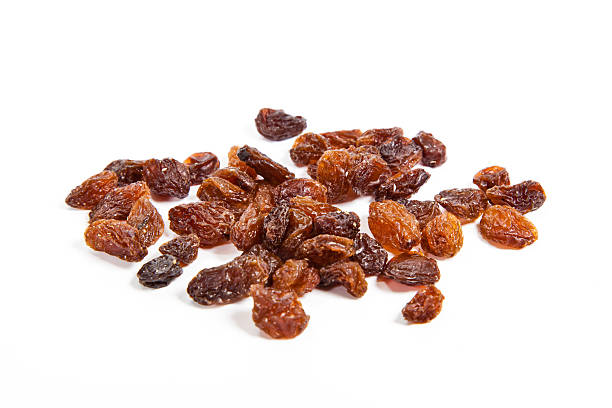 istock brown raisins on a white background 502557471