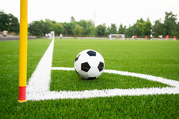 Football-Soccer green grass field, detail of the corner