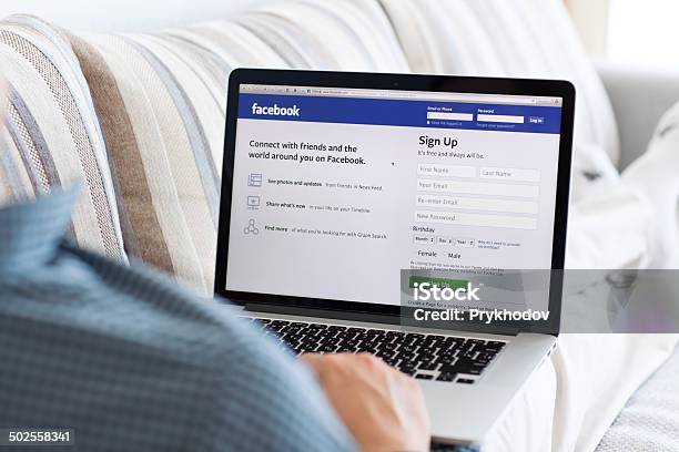 Man Sitting At The Macbook Retina With Site Facebook Stock Photo - Download Image Now